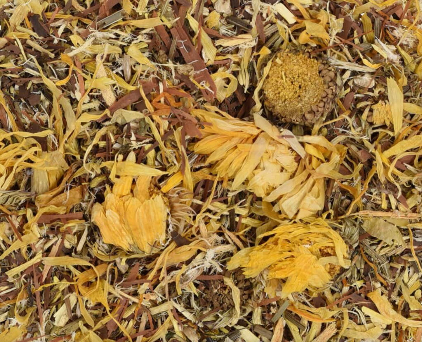 Close-up of dried Anti-Candida tea, showing chopped bark and flowers used for teas and herbal remedies.