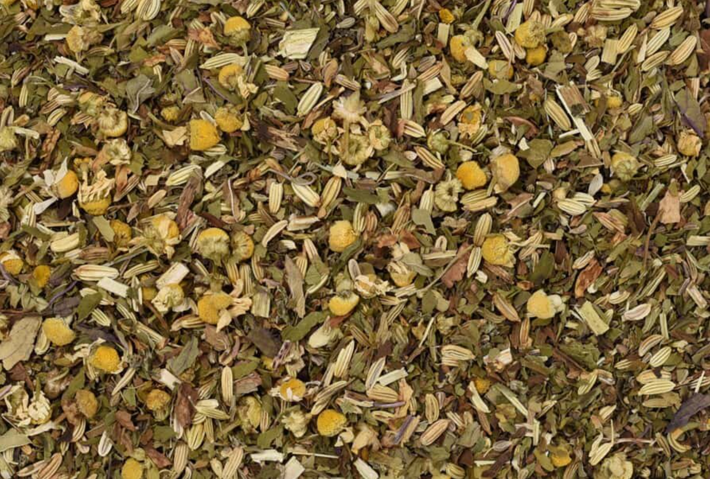 Close-up of dried Anti-Gas tea, showing chopped leaves, seeds, and flowers used for teas and herbal remedies.