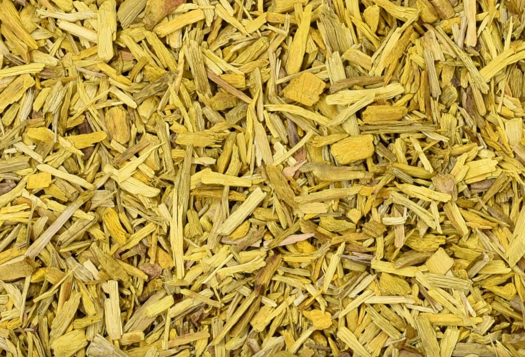 Close-up texture of dried barberry root, showing small yellow root pieces used for teas and herbal remedies.