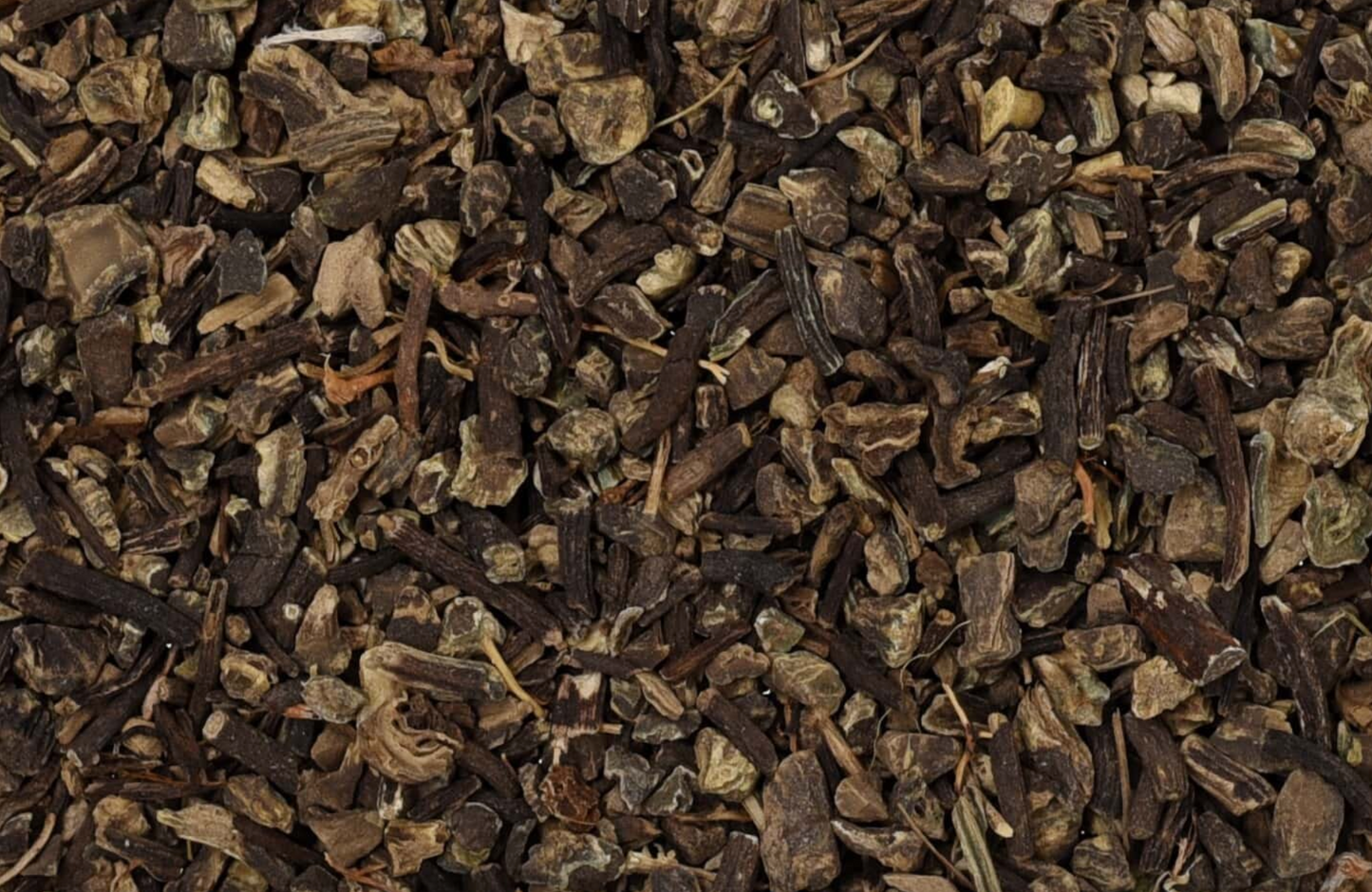 Close-up texture of dried black cohosh root, showing small dark brown pieces used for teas and herbal remedies.