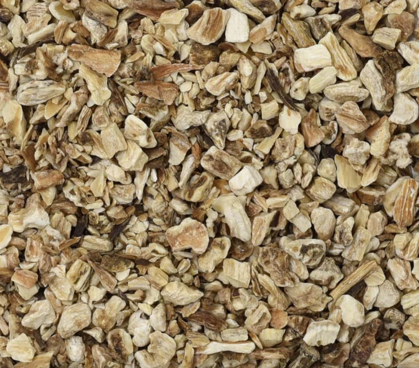 Close-up texture of dried burdock root, showing small beige and brown root pieces, used for teas and herbal remedies.