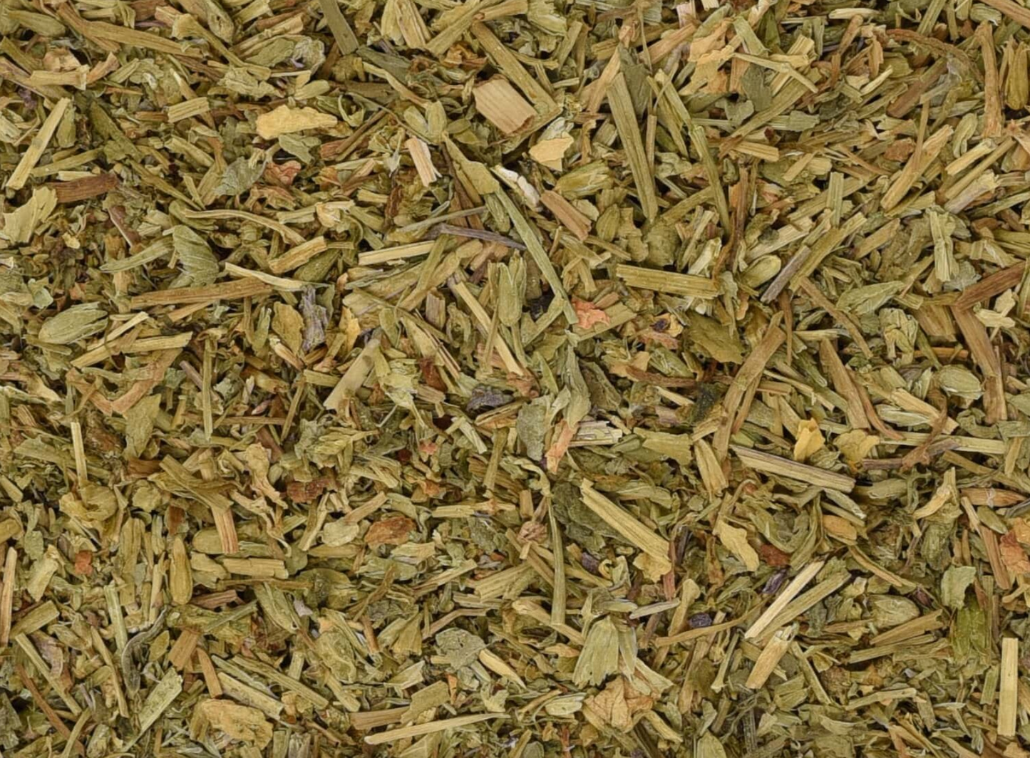 Close-up texture of dried chickweed herb, showing light green leaves used for teas and herbal remedies.