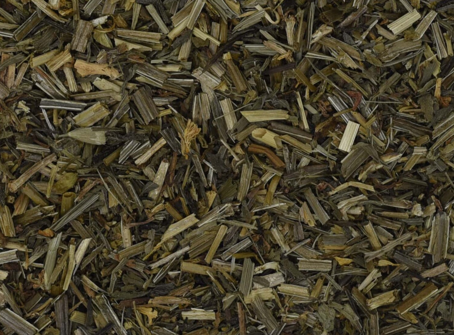Close-up texture of dried cleavers herb, showing green leaves used for teas and herbal remedies.