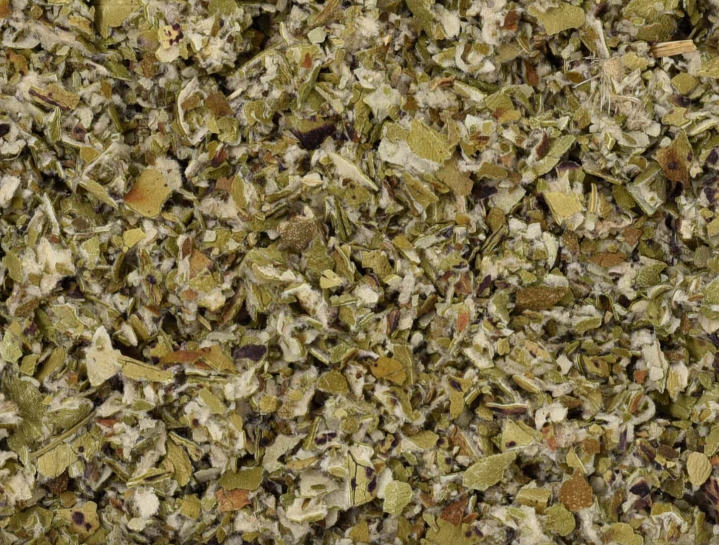 Close-up texture of dried coltsfoot herb, showing fluffy green leaves used for teas and herbal remedies.