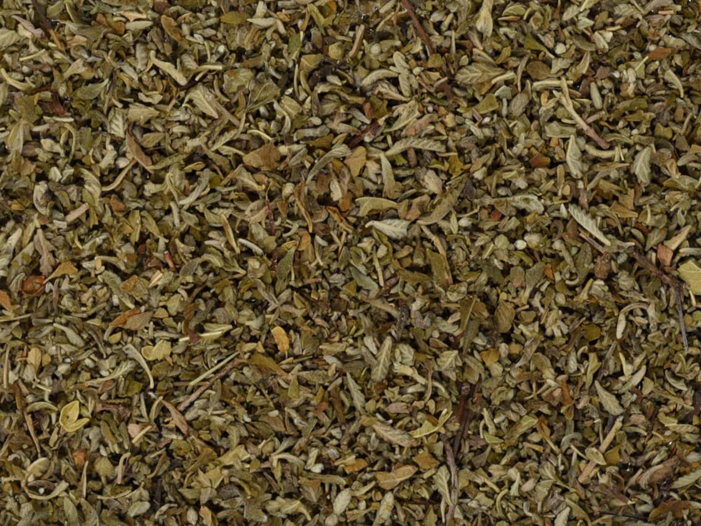 Close-up texture of dried damiana leaf, showing finely cut green leaves used for teas and herbal remedies.