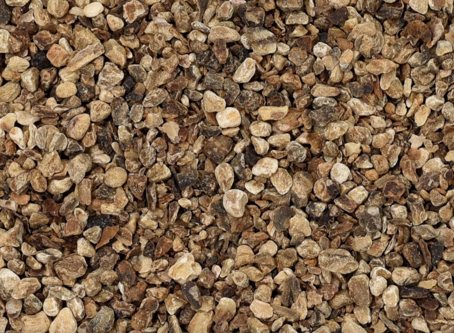 Close-up of dried devil's claw root, showing chopped root pieces used for teas and herbal remedies.