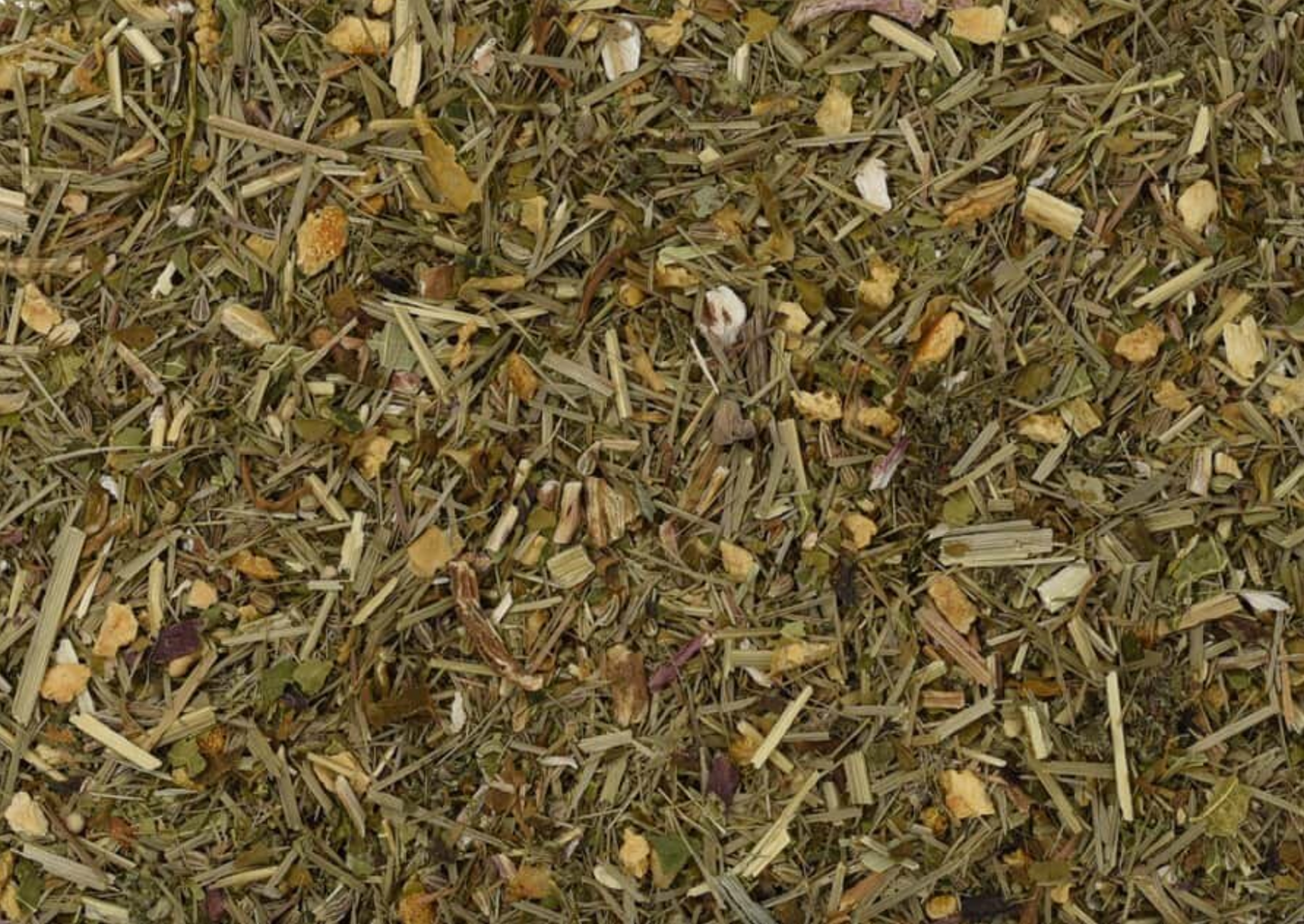 Close-up of dried Digestion Stimulating Tea, showing dried chopped leaves and orange peel pieces.