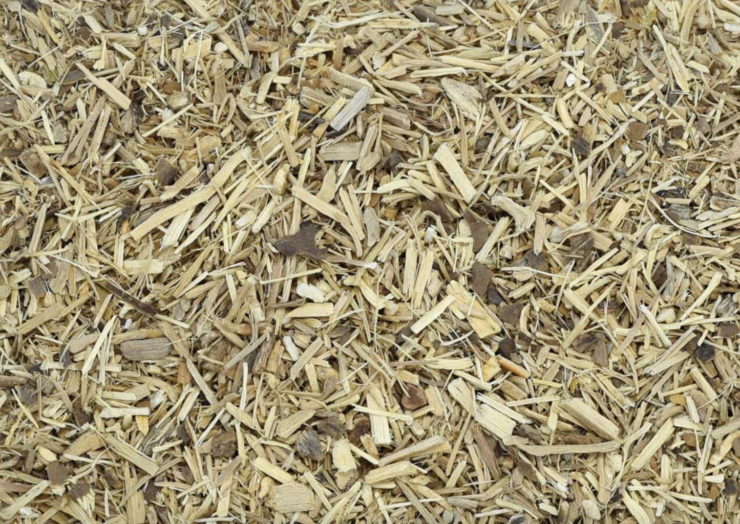 Close-up of dried ginseng root, showing finely cut beige pieces used for teas and herbal remedies.