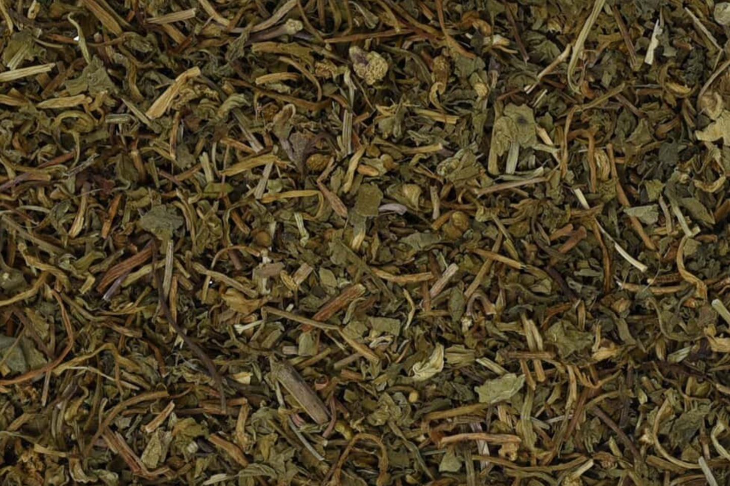 Close-up of dried gotu kola herb, showing chopped stems, leaves, and pieces used for teas and herbal remedies.