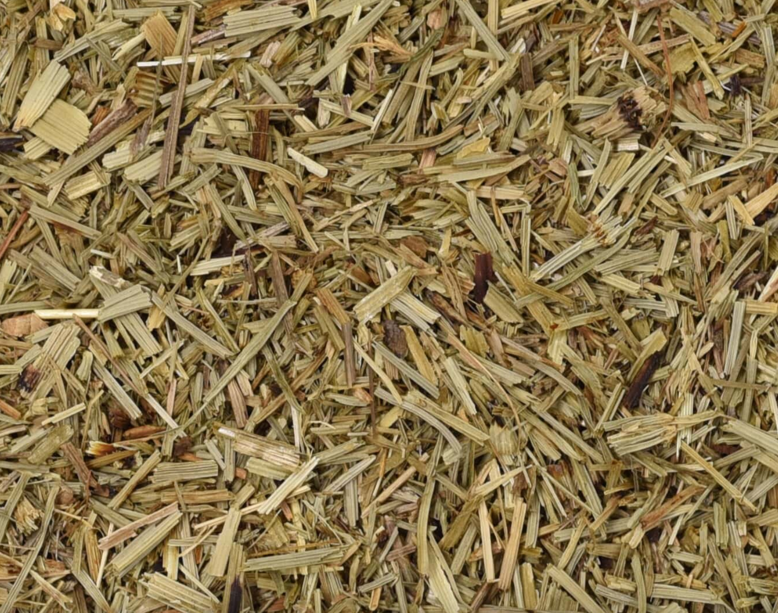Close-up texture of dried horsetail herb, showing small green herb pieces used for teas and herbal remedies.
