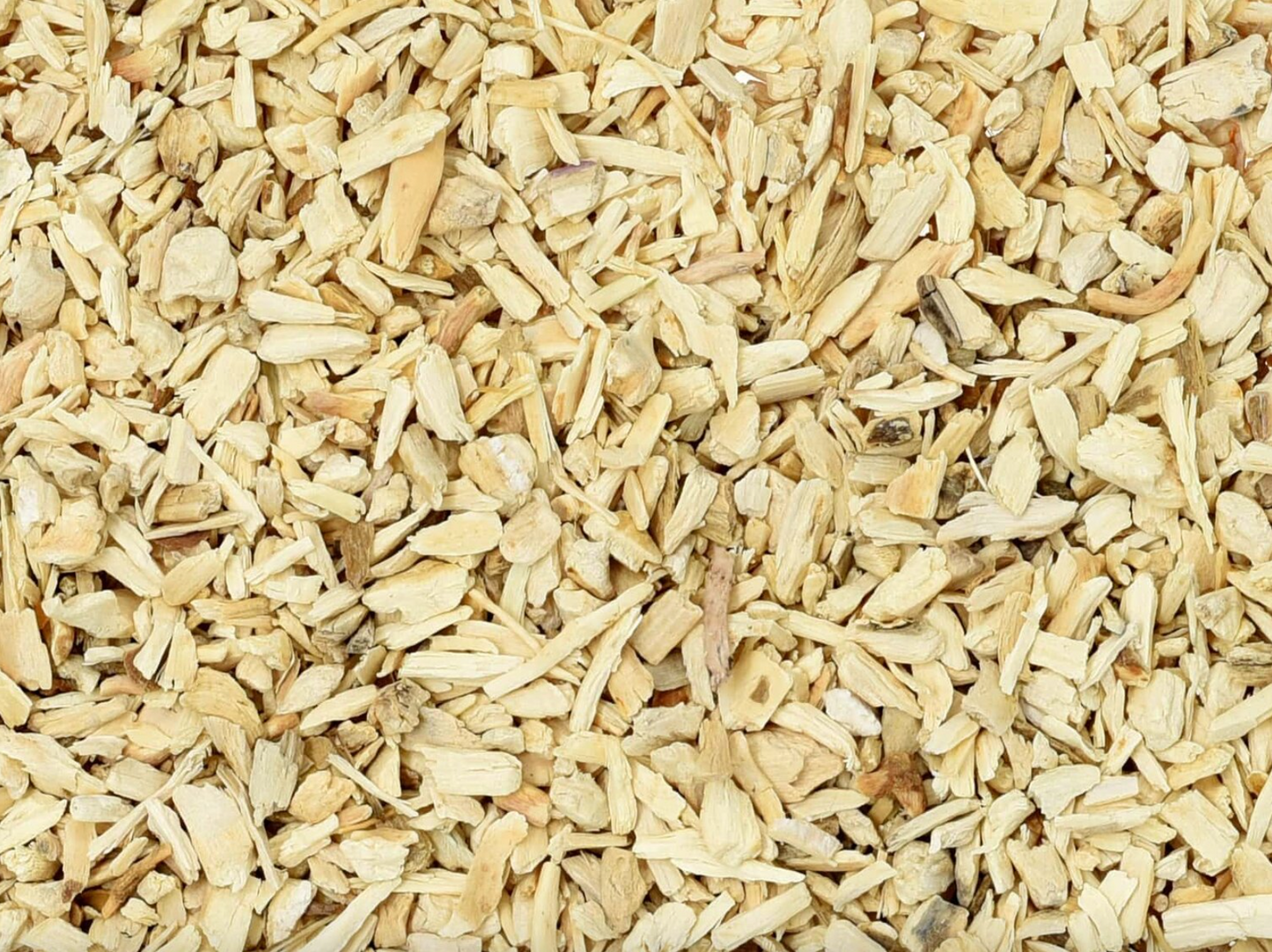 Close-up texture of dried hydrangea root, showing small beige root pieces used for teas and herbal remedies.