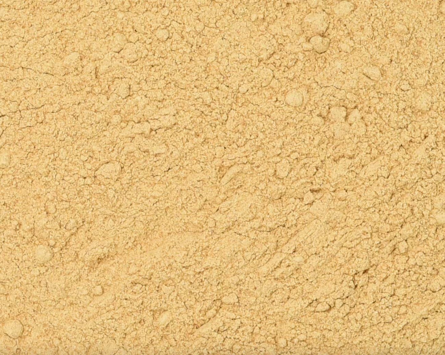 Close-up of dried maca powder, showing fine brown powder used for teas and herbal remedies.