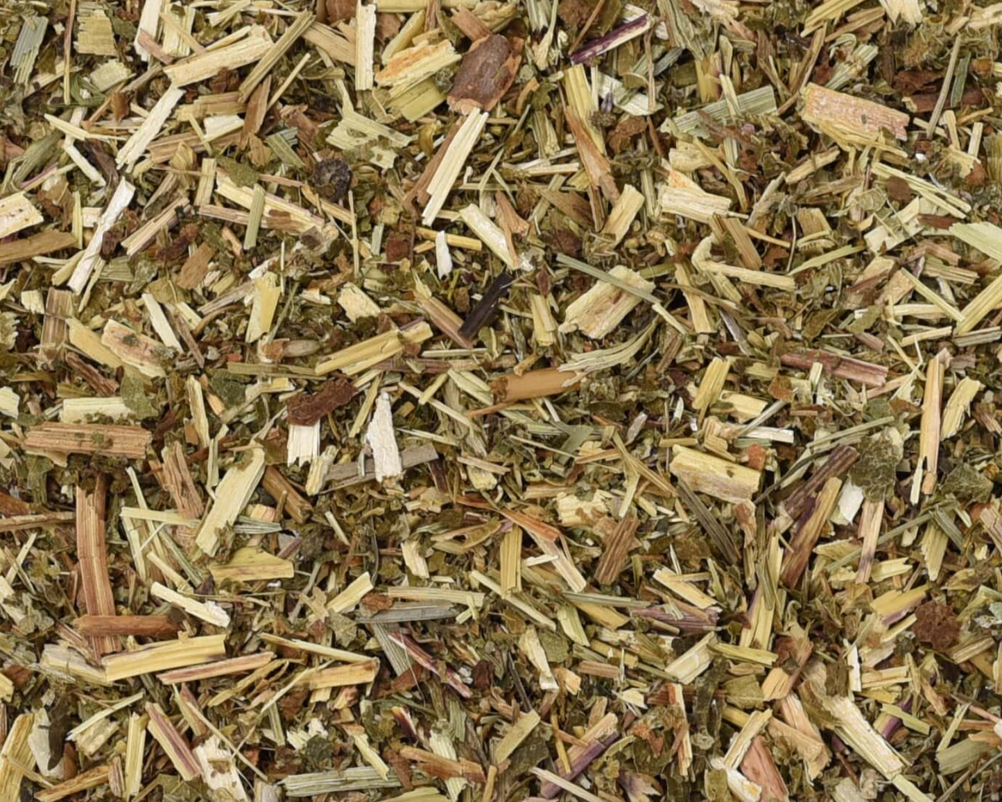Close-up of dried meadowsweet herb, showing chopped stems, leaves, and pieces used for teas and herbal remedies.