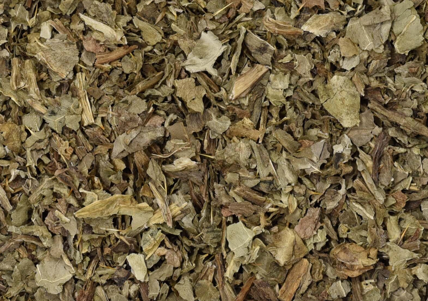Close-up of dried milk thistle leaf, showing chopped green leaves used for teas and herbal remedies.