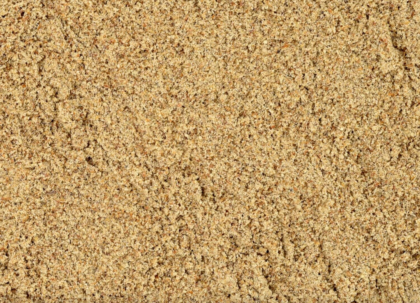 Close-up of dried milk thistle seed powder, showing fine beige powder used for teas and herbal remedies.