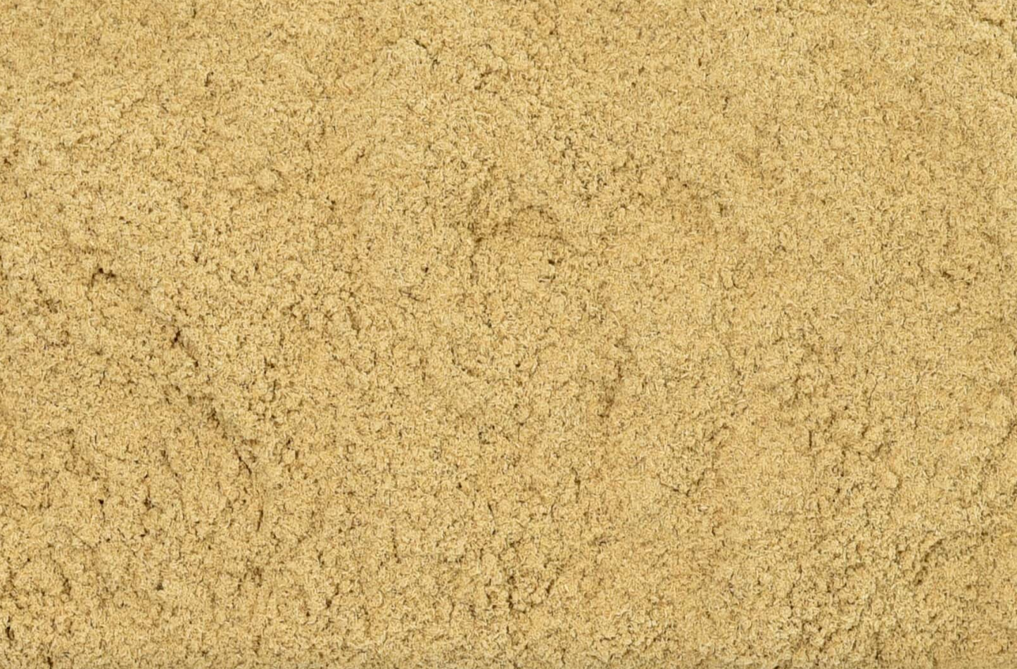 Close-up of dried muira puama powder, showing finely cut beige powder used for teas and herbal remedies.