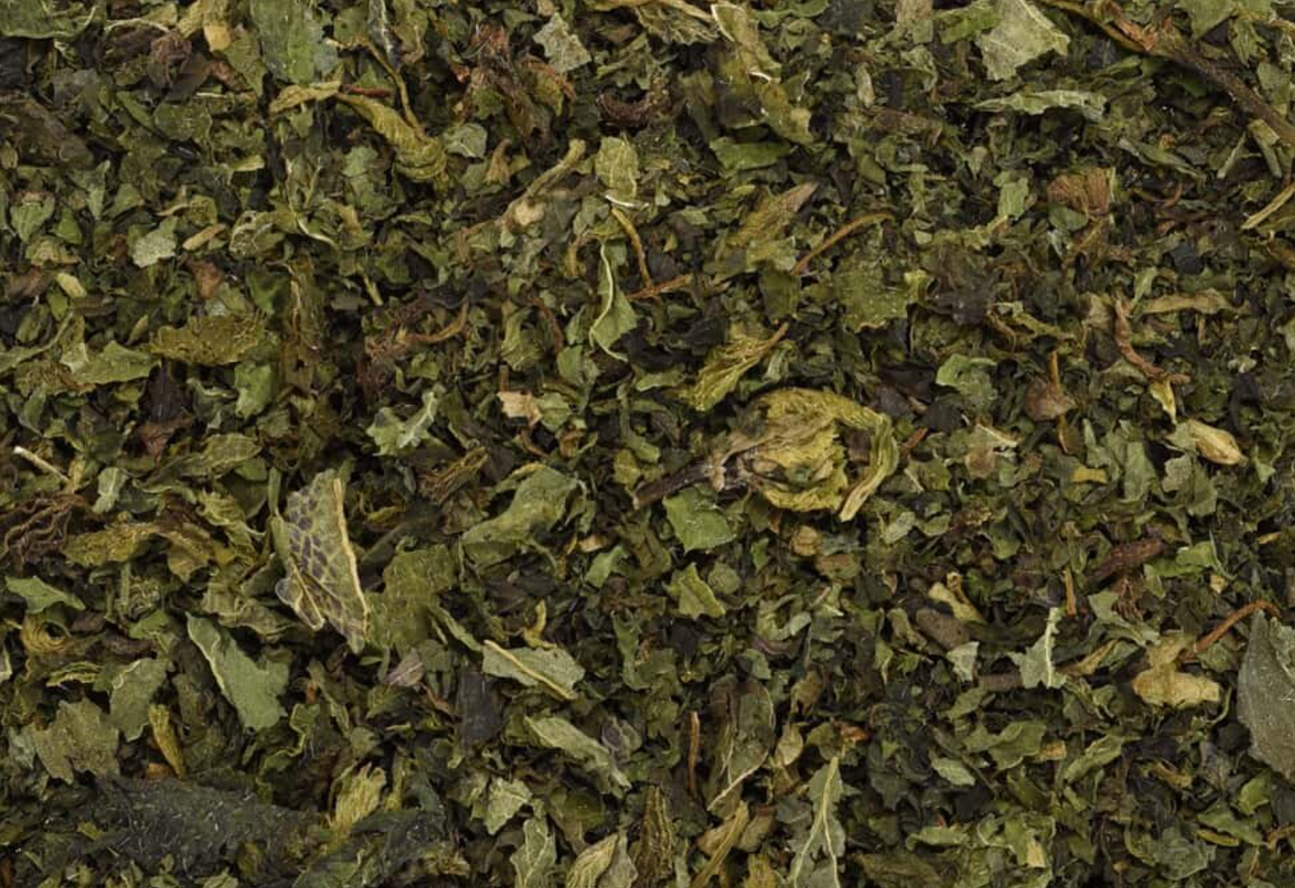 Close-up of dried nettle leaf, showing finely cut dark green leaves used for teas and herbal remedies.