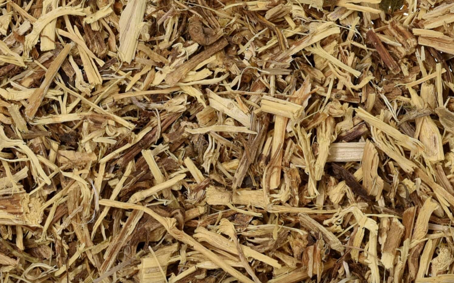 Close-up of dried nettle root, showing brown cut root used for teas and herbal remedies.
