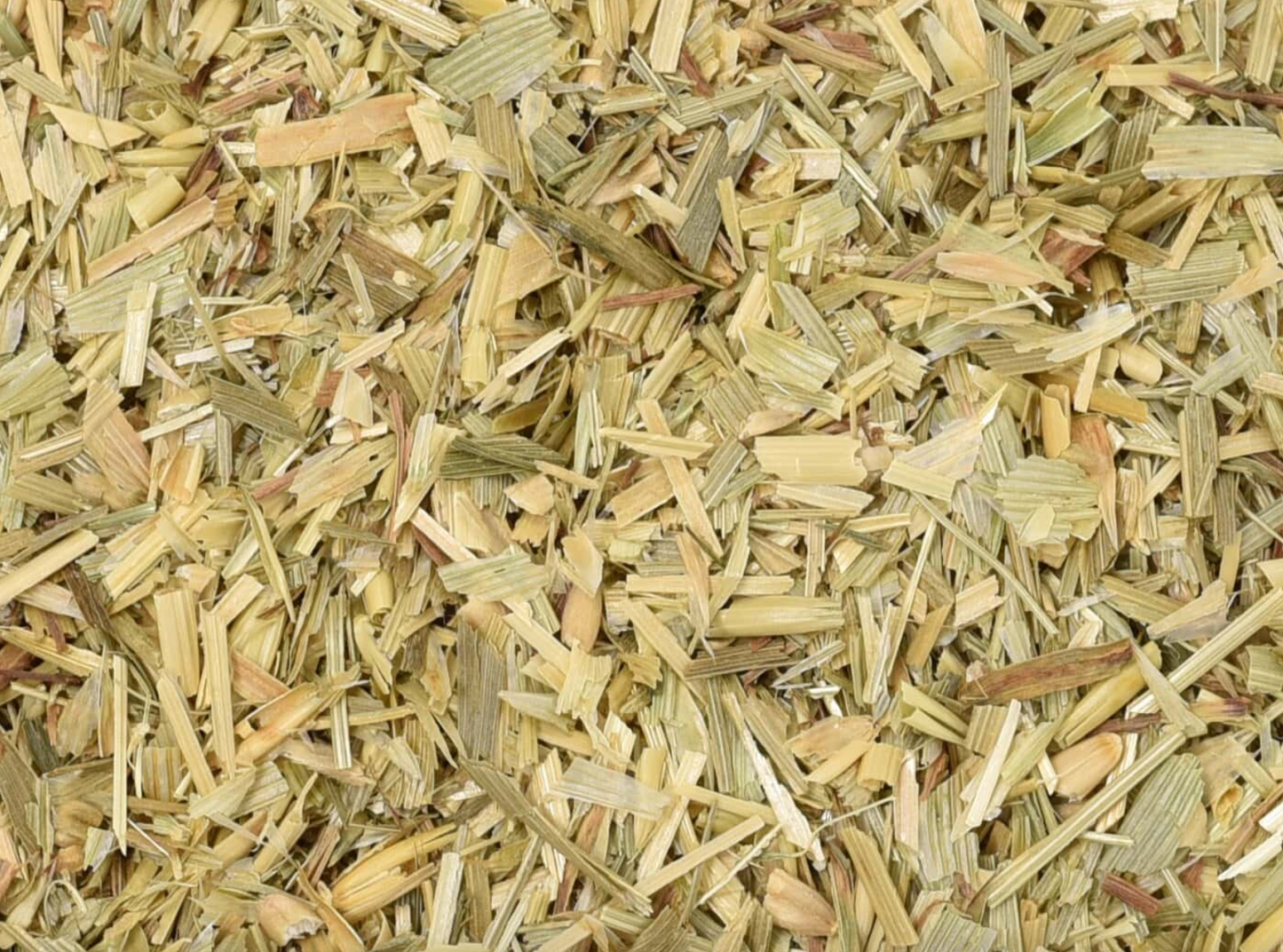 Close-up of dried oat straw, showing finely cut straw used for teas and herbal remedies.
