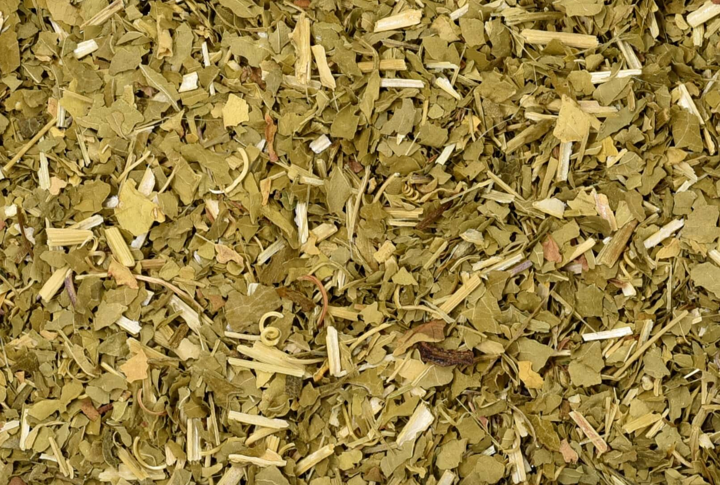 Close-up of dried passion flower herb, showing chopped stems, leaves, and pieces used for teas and herbal remedies.