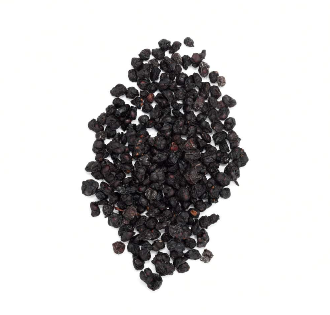 Close-up of dried schisandra berries, showing small dark red berries used for teas and herbal remedies.