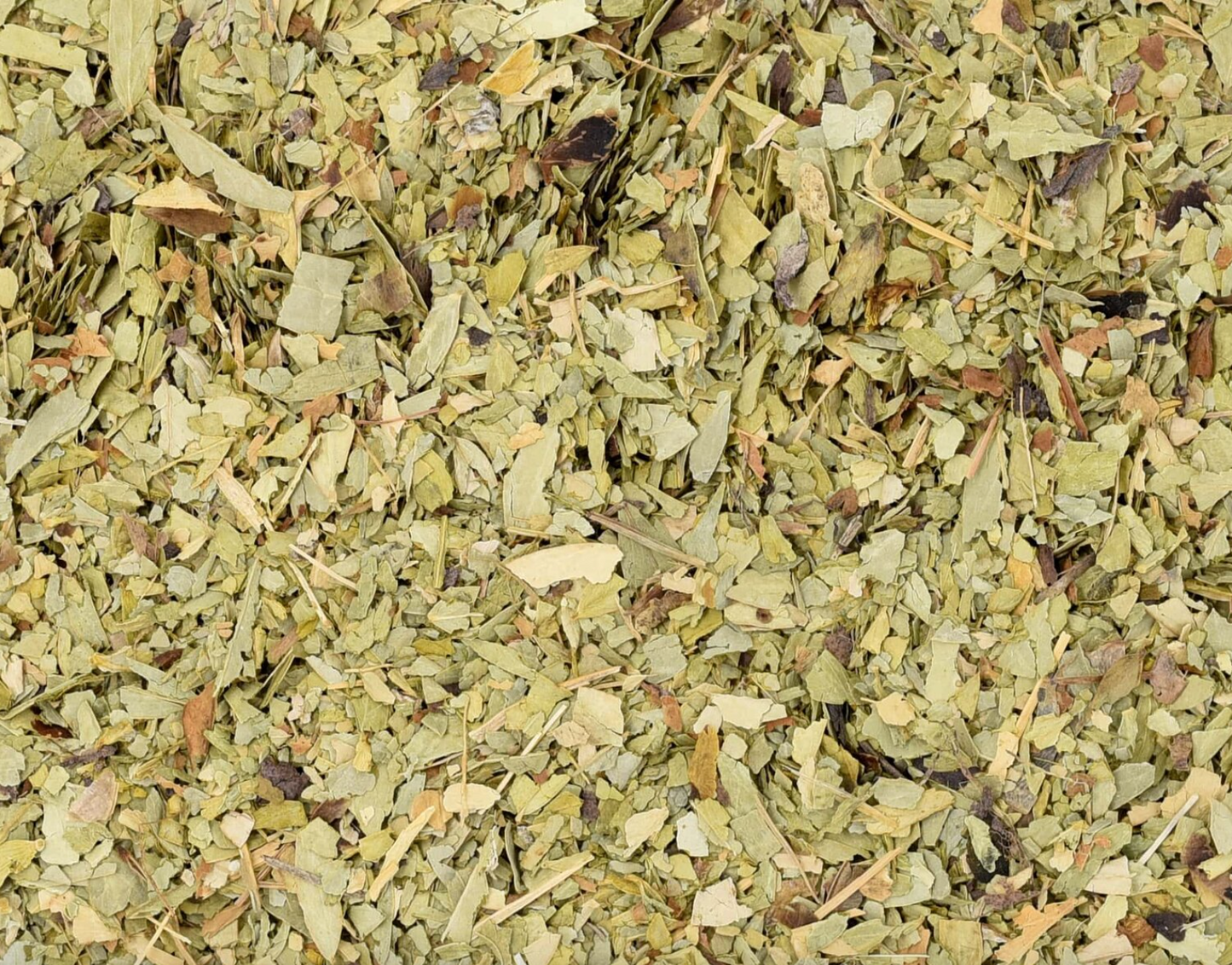 Close-up of dried senna leaf, showing chopped green leaves used for teas and herbal remedies.