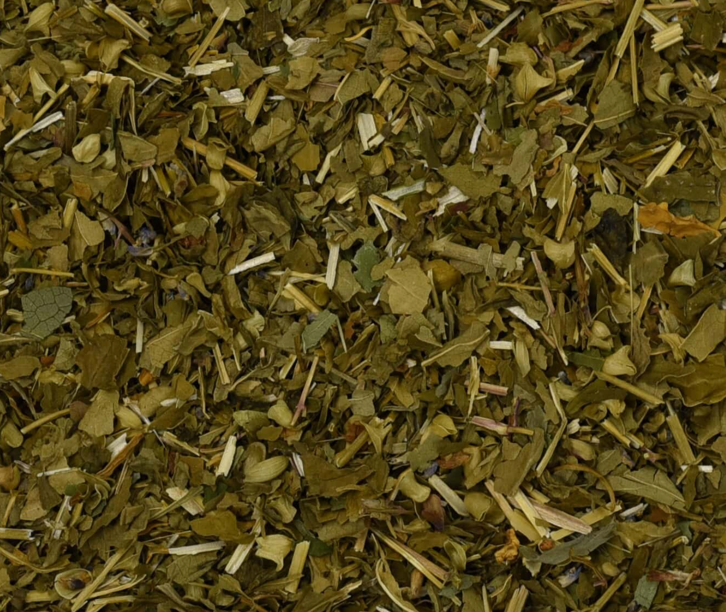 Close-up of dried skullcap herb, showing chopped stems, leaves, and pieces used for teas and herbal remedies.