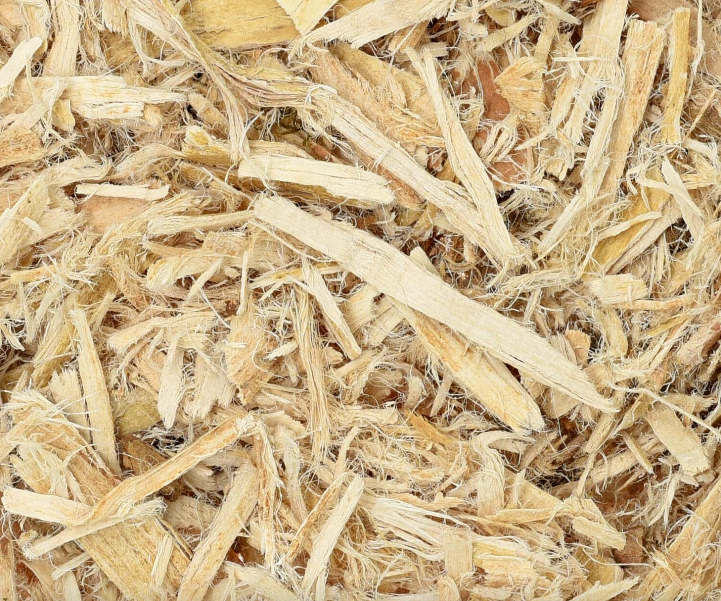 Close-up of dried slippery elm bark, showing beige chopped root pieces used for teas and herbal remedies.