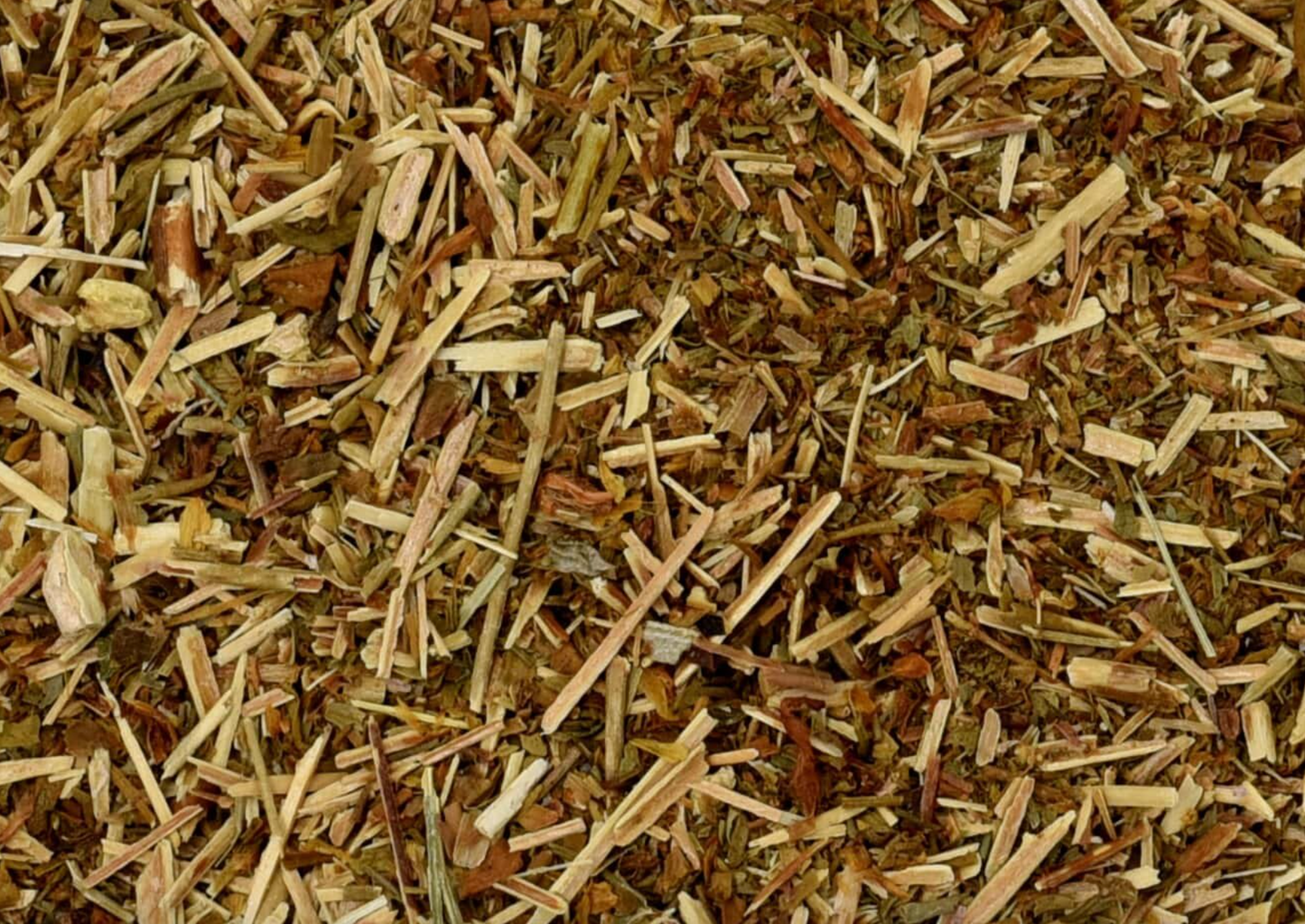 Close-up of dried St. John's wort herb, showing chopped stems, leaves, and pieces used for teas and herbal remedies.