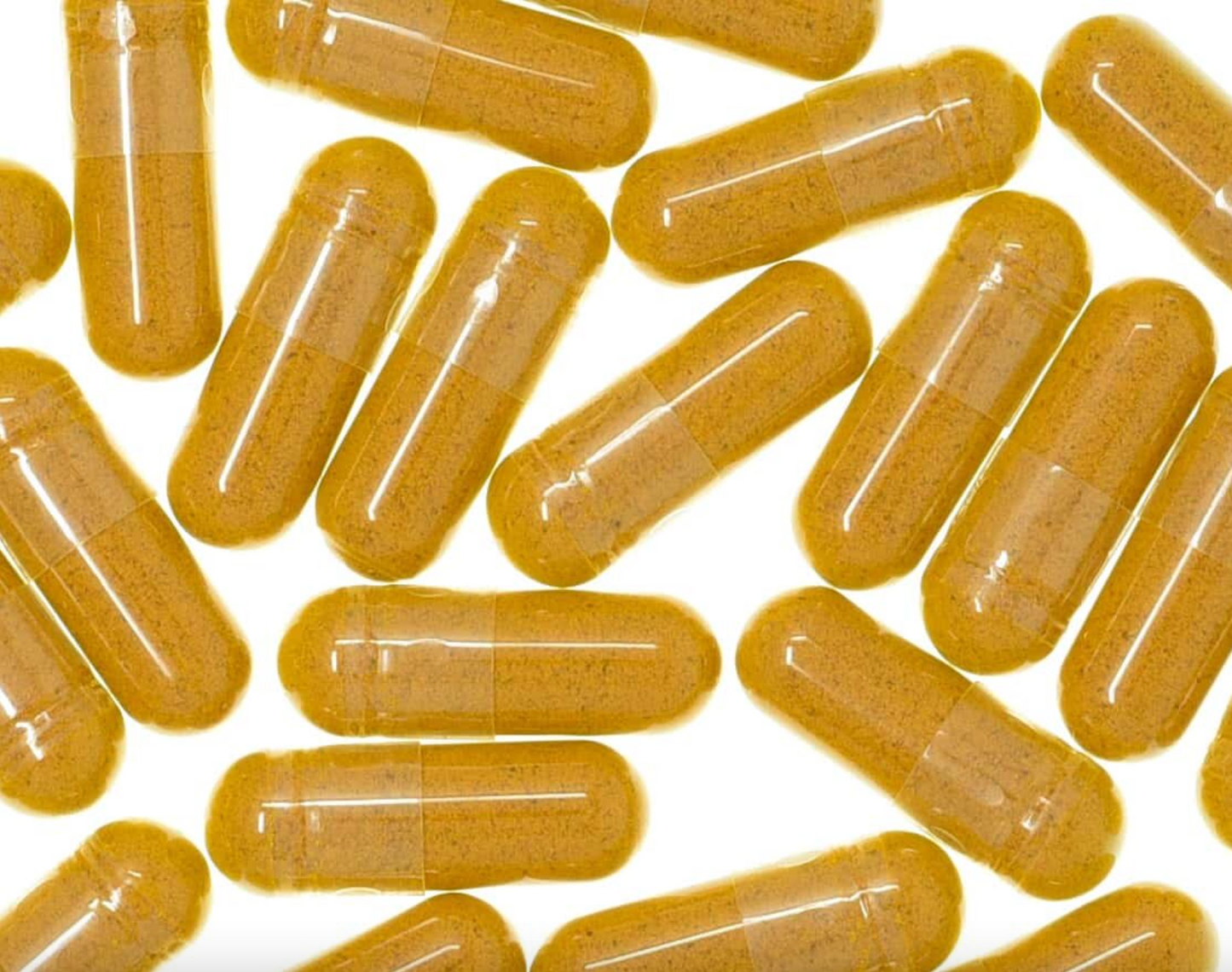 Turmeric root capsules with clear glossy shells, filled with orange powder, used for natural health and wellness.