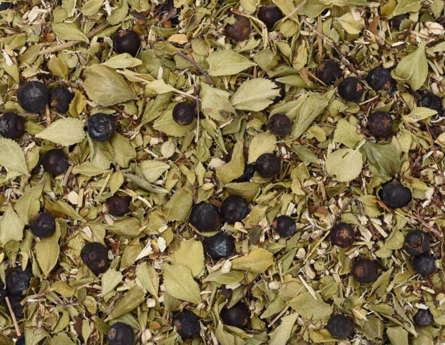 Close-up of dried UTI Recovery Tea, showing chopped leaves and berries used for teas and herbal remedies.