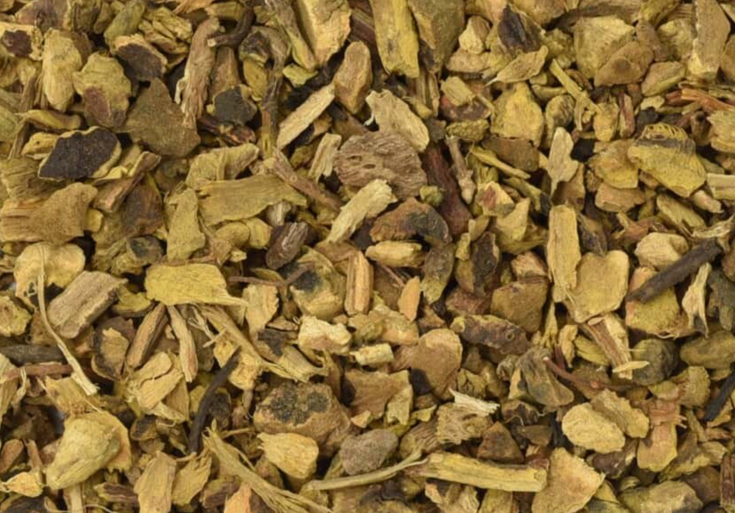 Close-up of dried yellow dock root, showing chopped brown root pieces used for teas and herbal remedies.