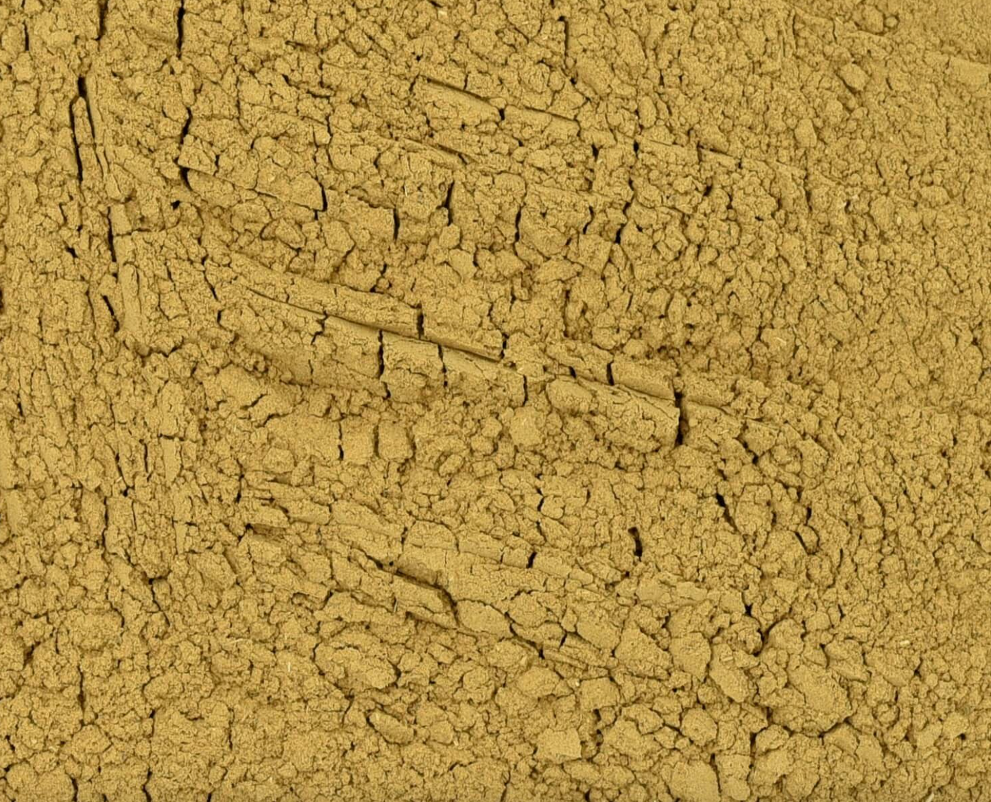 Close-up of dried yellow dock root powder, showing fine brown powder used for teas and herbal remedies.